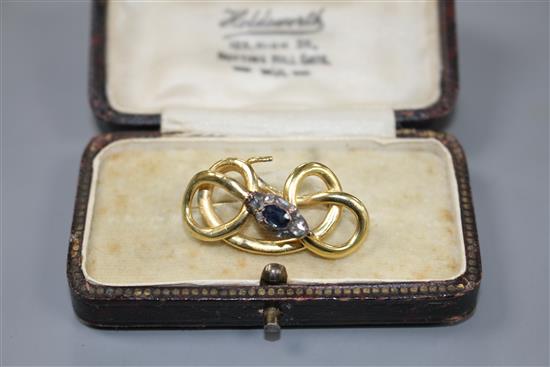 A late Victorian yellow and white metal, sapphire and diamond set scrolling serpent brooch, 32mm, gross 4.5 grams.